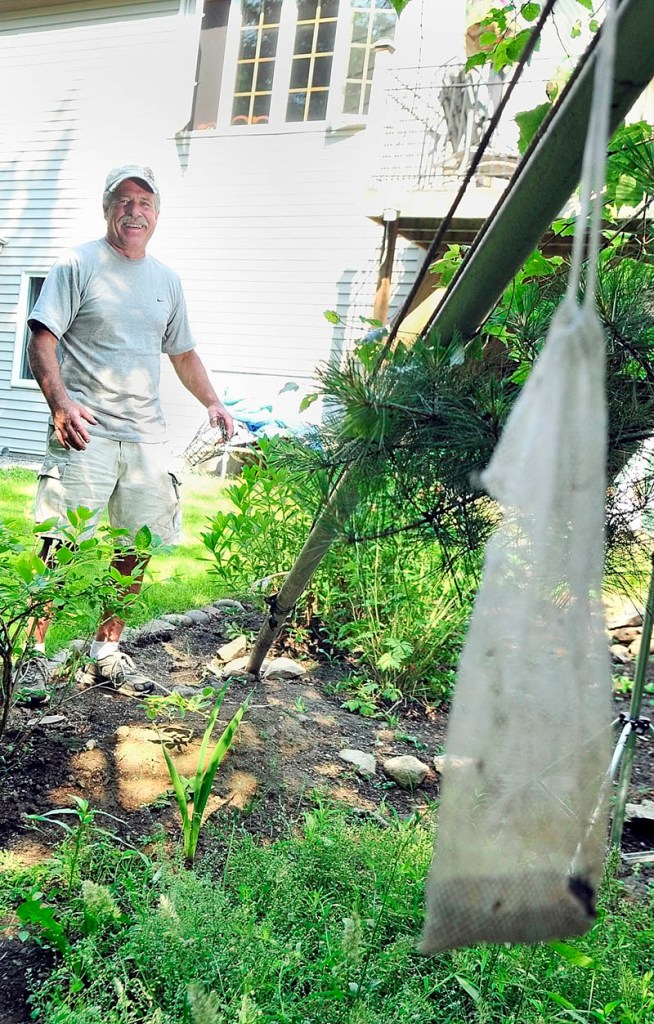 Jim Remley talks about the bear that recently knocked down a flag pole his Winthrop backyard. Remley used the pole to raise and lower bird feeders from which the bear was apparently trying to eat..