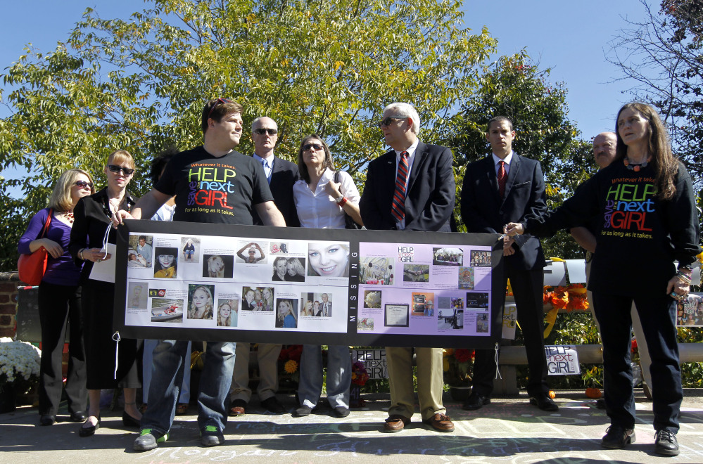 A banner showing the timeline of Morgan Harrington’s life and the impact her disappearance had on the community over time and in later cases is displayed along the Copeley Road bridge during a ceremony, Friday, in Charlotesville, Va. marking five years since her disappearance. Police say forensic evidence connects Jesse Leroy Matthew Jr., accused in the disappearance of a University of Virginia student Hannah Graham, to the 2009 slaying of Harrington, a 20-year-old Virginia Tech student.