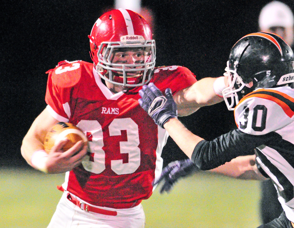 Cony running back Reid Shostak stiff-arms Gardiner’s Isaiah Swan during a regular season game at Alumni Field in Augusta. Shostak was named a James J. Fitzpatrick Trophy semifinalist Monday.