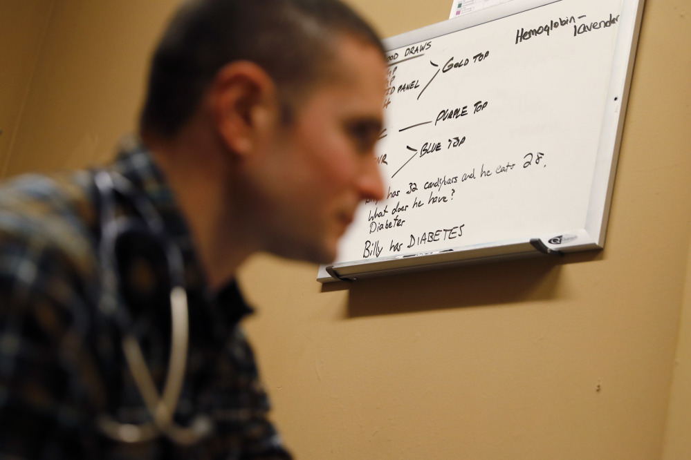 Physician assistant Brett Feldman listens to a patient during a check-up at a shelter in Easton, Pa. Feldman, 34, is one of the nation’s few practitioners of “street medicine,” a tiny health care niche that advocates predict will become more mainstream as hospitals and health care systems seek to cut costs, in part by reducing emergency-room visits among the homeless.