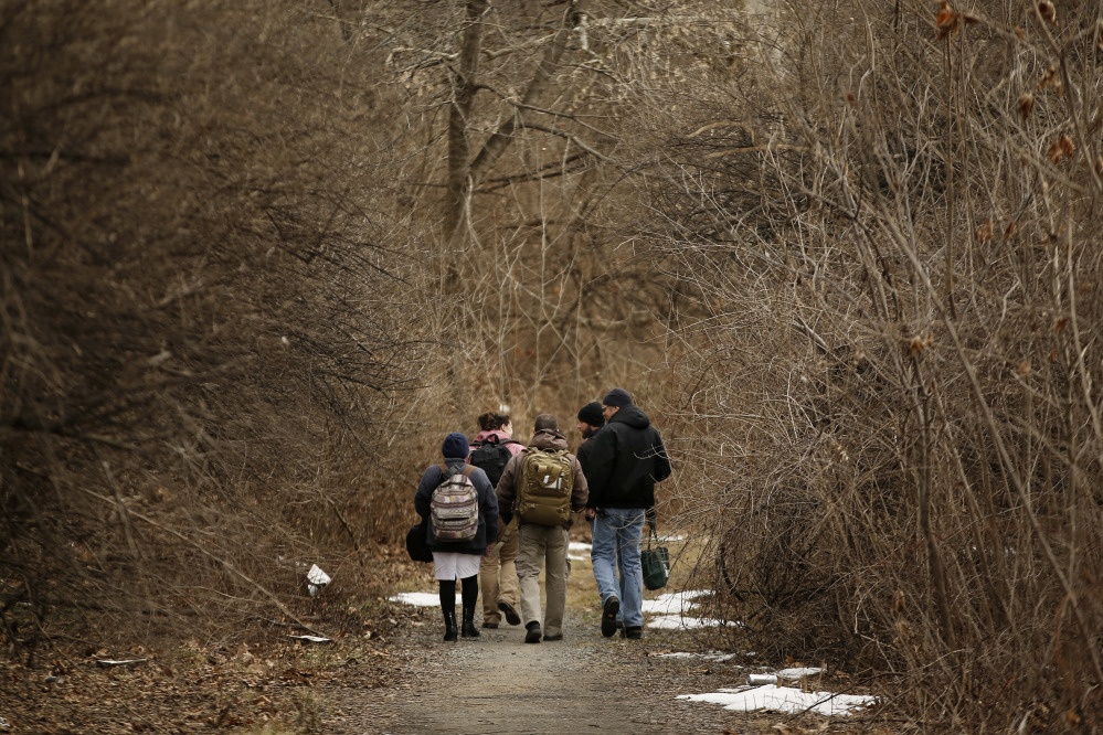 Medical assistant Lina Marin, from left, registered nurse Laura Lacroix, physician assistant Brett Feldman, military healthcare consultant Zach Laudenslager and community outreach specialist Bob Rapp walk to visit a homeless camp in Bethlehem, Pa.