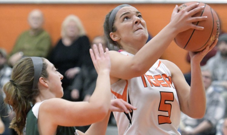 Gardiner's Anna Toman, right, goes up for for a basket in front of Leavitt's McKenna Redstone on Tuesday in Gardiner.